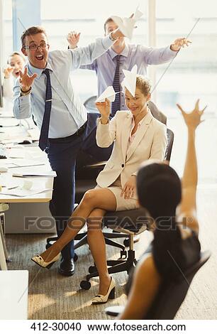 Playful business people throwing paper airplanes at each other in office View Large Photo Image Stock Image - Playful business people throwing paper airplanes at each other in office. Fotosearch