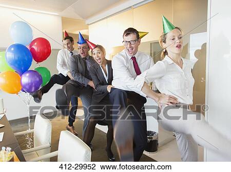 Playful business people with party hats dancing in conga line View Large Photo Image Stock Image - Playful business people with party hats dancing in conga line. Fotosearch