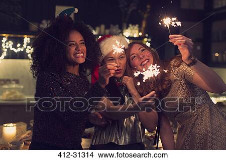 Playful young women with sparklers View Large Photo Image Picture - Playful young women with sparklers. Fotosearch