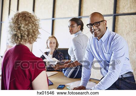 Portrait businessman smiling in conference room meeting View Large Photo Image Stock Photograph - Portrait businessman smiling in conference room meeting. Fotosearch