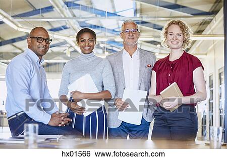 Portrait confident business people in conference room View Large Photo Image Stock Photograph - Portrait confident business people in conference room. Fotosearch