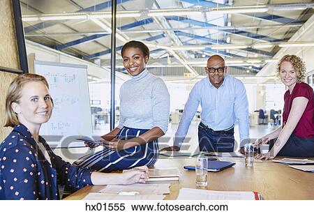Portrait confident business people in conference room meeting View Large Photo Image Stock Photography - Portrait confident business people in conference room meeting. Fotosearch