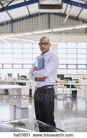 Stock Image - Portrait confident businessman in office. Fotosearch