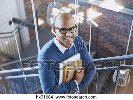 Portrait confident businessman in stairway View Large Photo Image Picture - Portrait confident businessman in stairway. Fotosearch