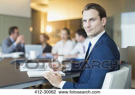 Portrait confident businessman in conference room meeting View Large Photo Image Stock Image - Portrait confident businessman in conference room meeting. Fotosearch