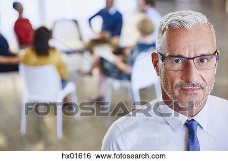 Portrait confident businessman outside meeting View Large Photo Image Stock Photograph - Portrait confident businessman outside meeting. Fotosearch