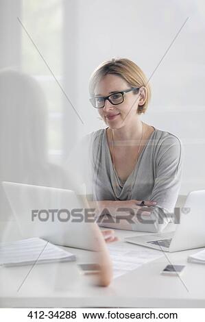 Portrait confident businesswoman working at laptop View Large Photo Image Stock Photo - Portrait confident businesswoman working at laptop. Fotosearch