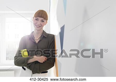 Portrait confident businesswoman leaning on wall View Large Photo Image Stock Photography - Portrait confident businesswoman leaning on wall. Fotosearch