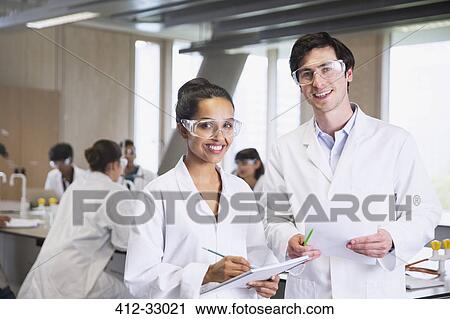 Portrait confident college students in lab coats in science laboratory classroom View Large Photo Image Stock Image - Portrait confident college students in lab coats in science laboratory classroom. Fotosearch