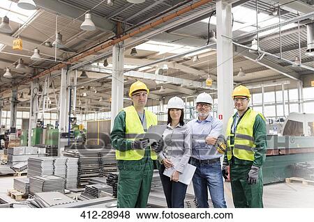 Stock Photo - Portrait confident engineers and workers in steel factory. Fotosearch