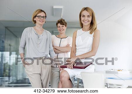 Portrait confident female architects in conference room View Large Photo Image Stock Photo - Portrait confident female architects in conference room. Fotosearch