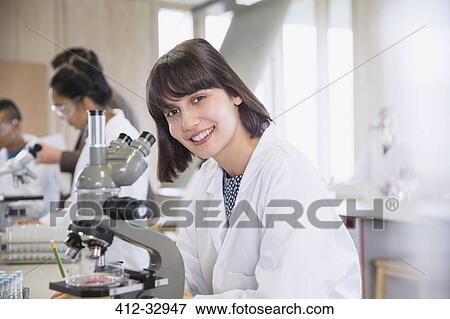 Portrait confident female college student using microscope in science laboratory classroom View Large Photo Image Stock Photo - Portrait confident female college student using microscope in science laboratory classroom. Fotosearch