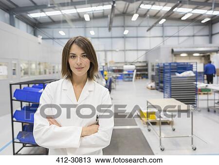 Stock Image - Portrait confident female engineer in steel factory. Fotosearch