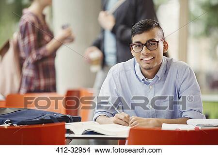 Portrait confident male college student studying in library View Large Photo Image Picture - Portrait confident male college student studying in library. Fotosearch