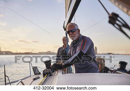 Portrait confident man sailing sailboat View Large Photo Image Picture - Portrait confident man sailing sailboat. Fotosearch