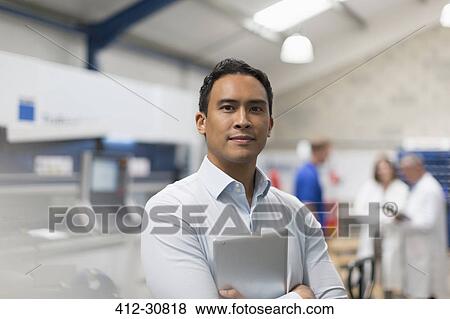 Portrait confident manager with digital tablet in steel factory View Large Photo Image Stock Photo - Portrait confident manager with digital tablet in steel factory. Fotosearch