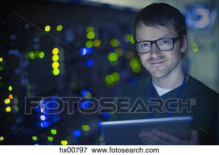 Portrait confident server room technician with digital tablet View Large Photo Image Stock Photo - Portrait confident server room technician with digital tablet. Fotosearch