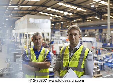 Portrait confident supervisors in steel factory View Large Photo Image Stock Photo - Portrait confident supervisors in steel factory. Fotosearch