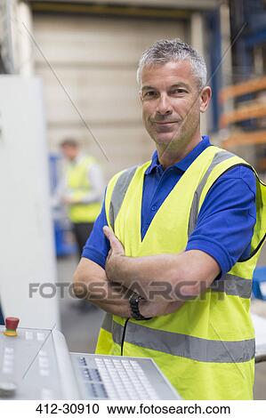 Portrait confident worker at control panel in steel factory View Large Photo Image Stock Image - Portrait confident worker at control panel in steel factory. Fotosearch