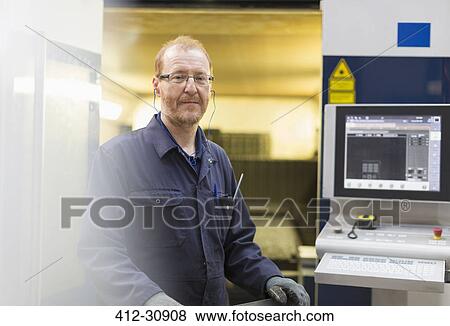 Portrait confident worker at control panel in steel factory View Large Photo Image Stock Photo - Portrait confident worker at control panel in steel factory. Fotosearch