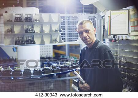 Stock Image - Portrait confident worker in steel factory. Fotosearch