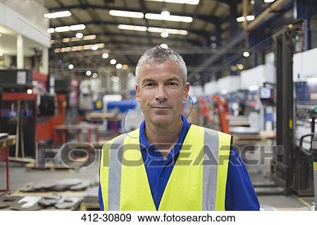 Stock Photo - Portrait confident worker in steel factory. Fotosearch