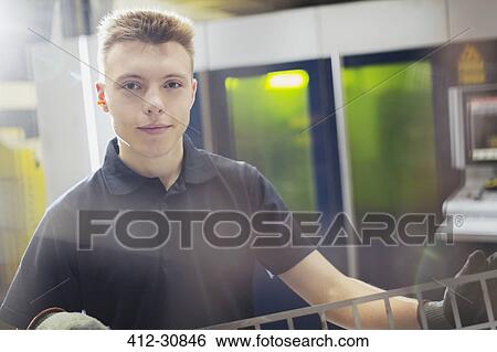 Stock Photograph - Portrait confident worker in steel factory. Fotosearch
