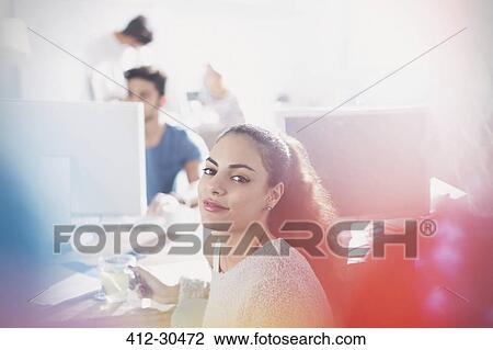 Portrait confident young creative businesswoman working in office View Large Photo Image Stock Image - Portrait confident young creative businesswoman working in office. Fotosearch