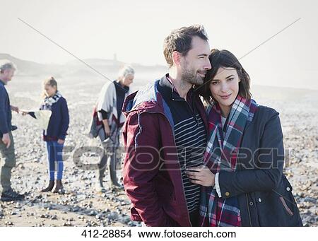 Portrait couple hugging on sunny rocky beach View Large Photo Image Picture - Portrait couple hugging on sunny rocky beach. Fotosearch