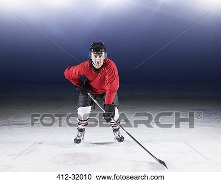 Portrait determined hockey player in red uniform on ice View Large Photo Image Stock Image - Portrait determined hockey player in red uniform on ice. Fotosearch