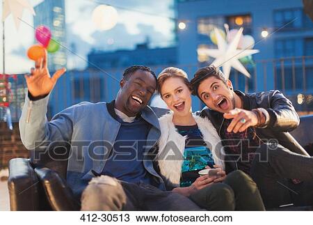 Portrait enthusiastic friends enjoying rooftop party View Large Photo Image Stock Image - Portrait enthusiastic friends enjoying rooftop party. Fotosearch