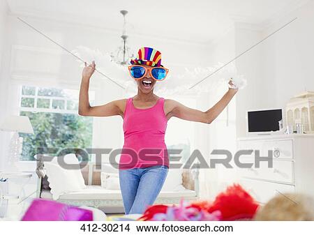 Portrait enthusiastic mature woman wearing feather boa and large sunglasses View Large Photo Image Picture - Portrait enthusiastic mature woman wearing feather boa and large sunglasses. Fotosearch