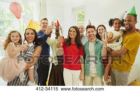 Portrait enthusiastic multi-ethnic multi-generation family celebrating party with champagne and party hats View Large Photo Image Stock Photography - Portrait enthusiastic multi-ethnic multi-generation family celebrating party with champagne and party hats. Fotosearch