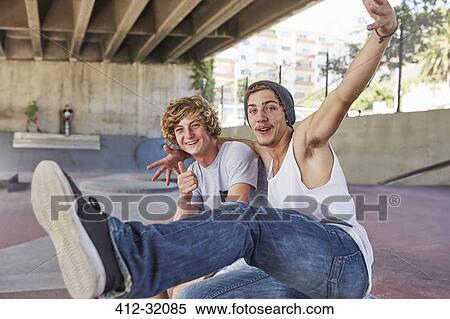 Portrait enthusiastic teenage boys gesturing at skate park View Large Photo Image Stock Photography - Portrait enthusiastic teenage boys gesturing at skate park. Fotosearch