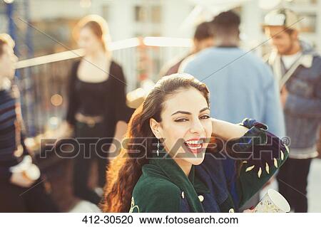 Portrait enthusiastic young woman enjoying rooftop party View Large Photo Image Stock Image - Portrait enthusiastic young woman enjoying rooftop party. Fotosearch