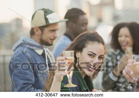 Portrait enthusiastic young woman drinking champagne at party View Large Photo Image Stock Photo - Portrait enthusiastic young woman drinking champagne at party. Fotosearch