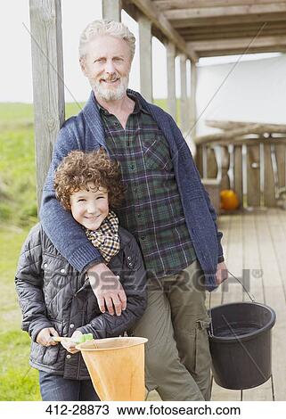Portrait grandfather and grandson with bucket and net on porch View Large Photo Image Stock Image - Portrait grandfather and grandson with bucket and net on porch. Fotosearch