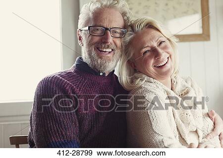 Stock Photo - Portrait laughing senior couple hugging. Fotosearch