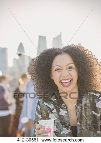 Portrait laughing young woman drinking at party View Large Photo Image Stock Image - Portrait laughing young woman drinking at party. Fotosearch