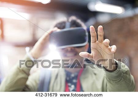 Portrait man trying virtual reality simulator glasses reaching View Large Photo Image Stock Photo - Portrait man trying virtual reality simulator glasses reaching. Fotosearch