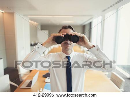 Portrait of businessman using binoculars in conference room View Large Photo Image Stock Photography - Portrait of businessman using binoculars in conference room. Fotosearch