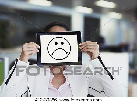 Portrait of businesswoman covering face with digital tablet in office View Large Photo Image Stock Photograph - Portrait of businesswoman covering face with digital tablet in office. Fotosearch