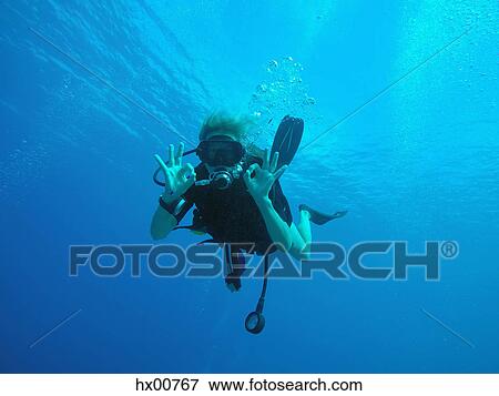 Portrait of confident scuba diver gesturing okay underwater View Large Photo Image Stock Photo - Portrait of confident scuba diver gesturing okay underwater. Fotosearch