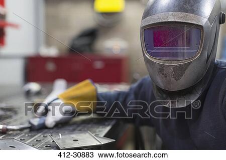 Portrait of welder in welding helmet in steel factory View Large Photo Image Stock Image - Portrait of welder in welding helmet in steel factory. Fotosearch