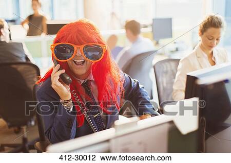 Portrait playful businessman wearing red wig and huge sunglasses in office View Large Photo Image Stock Image - Portrait playful businessman wearing red wig and huge sunglasses in office. Fotosearch