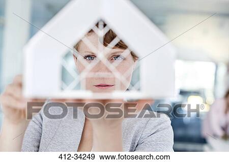 Stock Photo - Portrait serious architect examining model. Fotosearch