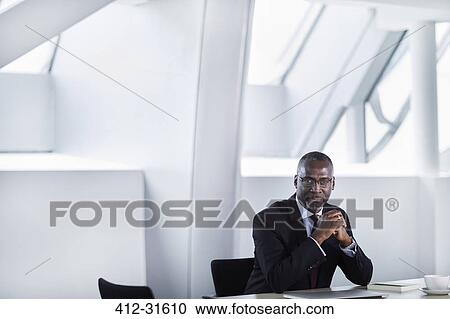 Portrait serious businessman in modern conference room View Large Photo Image Stock Image - Portrait serious businessman in modern conference room. Fotosearch
