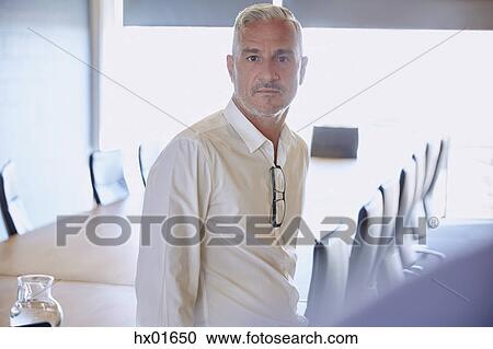 Portrait serious businessman in conference room View Large Photo Image Stock Image - Portrait serious businessman in conference room. Fotosearch