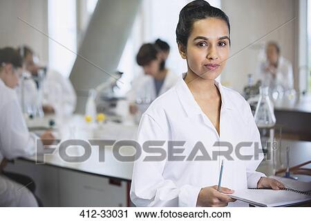 Stock Image - Portrait serious female college student in science laboratory classroom. Fotosearch