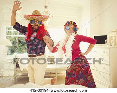 Picture - Portrait silly mature couple dancing in costumes. Fotosearch